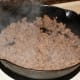 When the meat is cooked, spread it out and add the mushrooms. Cook until meat is no longer pink.