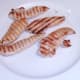 Chicken strips are removed from griddle to rest