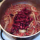 Red kidney beans are added to chilli