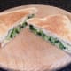 Broccoli and bacon cheese toastie is sliced for serving