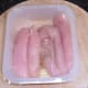 Oiled and seasoned chicken breast strips