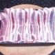 bacon strips laid in buttered loaf tin