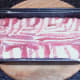 Bacon edges are folded over top of meatloaf