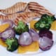 Vegetables are slid from skewers on to plate