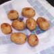 Pan roasted potatoes are drained on kitchen paper