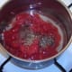 Tomatoes and seasonings added to sweated garlic