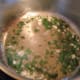 In a saucepan on a stove burner, put the butter, garlic, wine and cilantro in the pan.