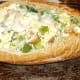 Spoon eggs into hoagie roll, add grated Asiago cheese and bake at 350 degrees until cheese melts