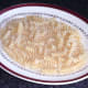 Fusilli pasta bed is laid out for stuffed mushrooms