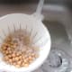 Canned chickpeas are washed under running cold water