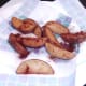 Chilli powder is scattered over potato wedges