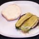 Pickles are laid on cheese stuffed mushrooms