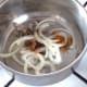 Onion and seasonings are added to pot with oil