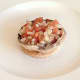 Tomato and onion stuffed mushroom is laid on toast