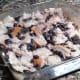 The bread squares are mashed with a fork so that they will soak up the milk-egg mixture.