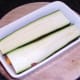 Two sliuces of zucchini are laid on first layer of spicy beef