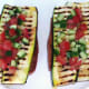 Salsa is spooned on to zucchini bruschetta