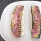 Pancetta is laid on zucchini slices