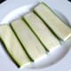 Zucchini slices are salted and set aside