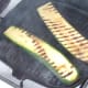Zucchini slices are turned in griddle pan
