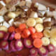 Preheat your oven to 350°F and chop the carrots, potatoes and onions. Chop the garlic into small pieces.