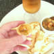 Curry and green chilli potted crayfish tails is spooned on to mini poppadoms