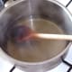 Gelatine leaves are melted in warm stock