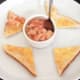 Spooning potted crayfish tails on to hot buttered toast