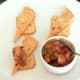 Spooning fajitas spiced and bell pepper potted crayfish tails on to Mexicana cheese and crackers