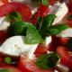 Fresh tomatoes layered with mozzarella and fresh basil leaves
