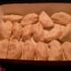 Apple dumplings wrapped in refrigerated crescent roll dough, prior to baking.