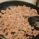 Break up and brown the sausage.