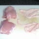 Skin is pulled from chicken thighs