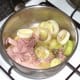 Sliced leek is added to fried bacon