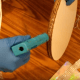 Hot glue around the perimeter. You may need to do this a little at a time, depending on the temperature of your kitchen.