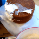 Use a small amount of icing and work your way around the cake.