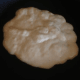 Put your pancake down in the pan either using your dispenser or a 1/3 cup measuring cup or a ladle. I'm using a non-stick skillet, but you can opt to add butter or oil to the pan if you are using an iron skillet.