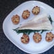 Potato crowns are arranged either side of cod
