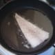 Cod is laid skin side down in frying pan