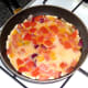 Beaten eggs are poured in to pan