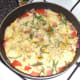 Final pepper seasoning is scattered over tortilla