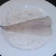 Cod is patted in seasoned flour