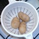 Boiled potatoes are drained and cooled