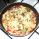 Cheese is scattered over tortilla