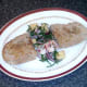Bruschetta is plated alongside samphire salad