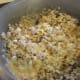 Mixing the cereal with the marshmallow and butter mixture.