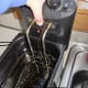I remove the basket and the immersion heater and place them in the sink.