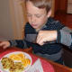 Tucking into a delicious plate of potato pancakes.