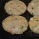 Shallow-frying the tikkis.