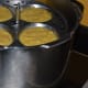 Idli moulds inside the cooker.